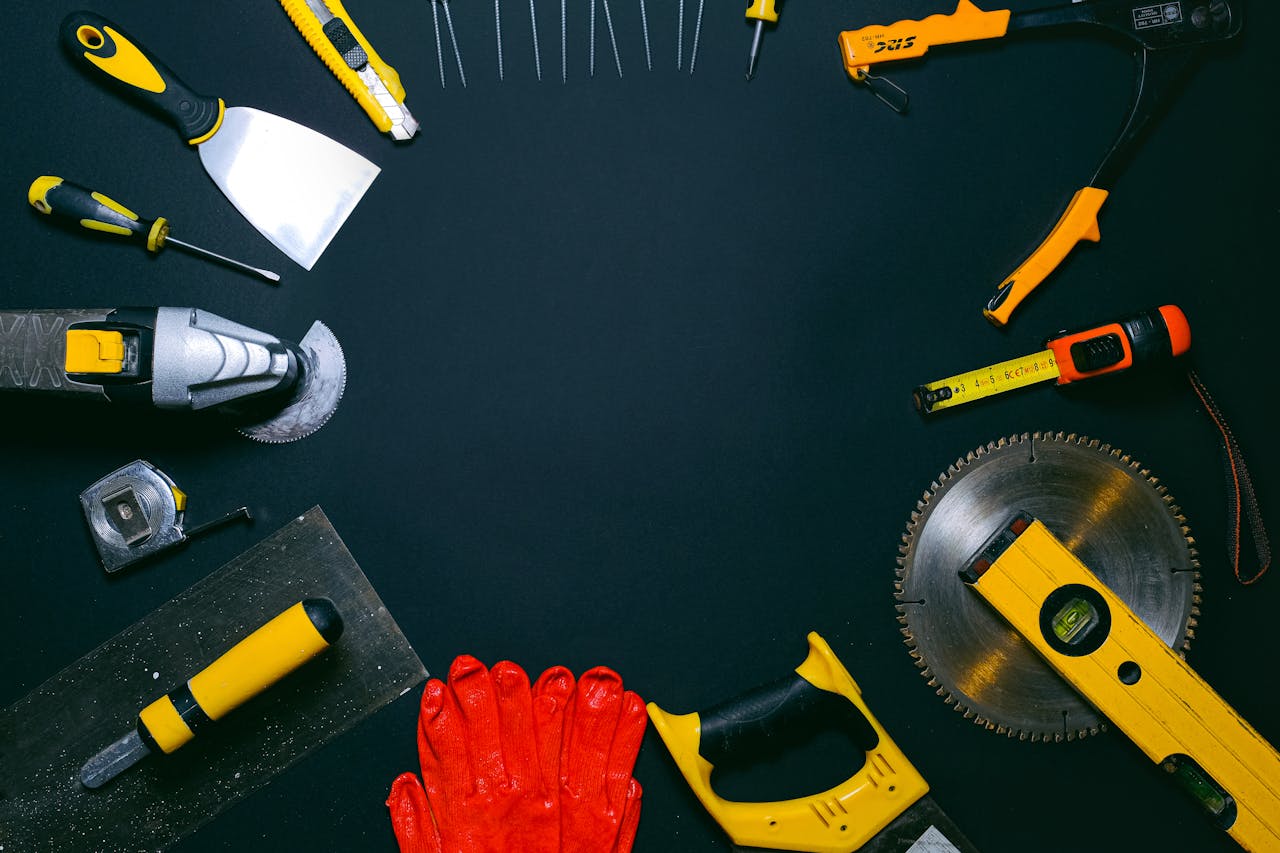 services-img-02 A collection of hand tools laid out on a dark surface, perfect for construction themes.